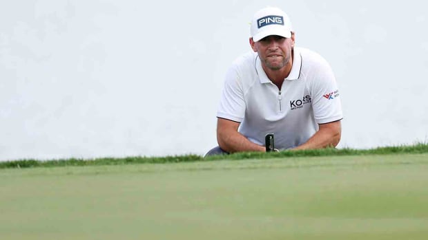 Austin Eckroat lines up a putt on the 14th green during the continuation of the weather delayed final round of the 2024 Cognizant Classic in The Palm Beaches at PGA National Resort in Palm Beach Gardens, Fla.